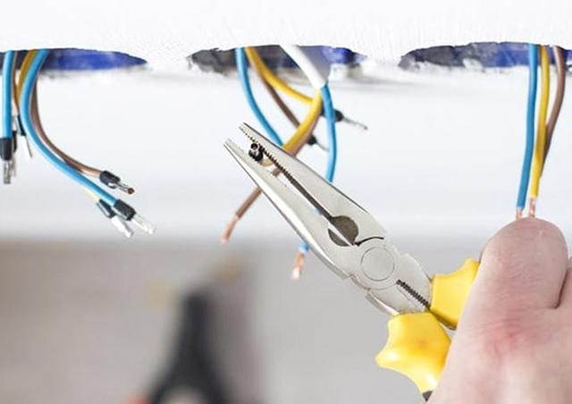 Electrician stripping wires